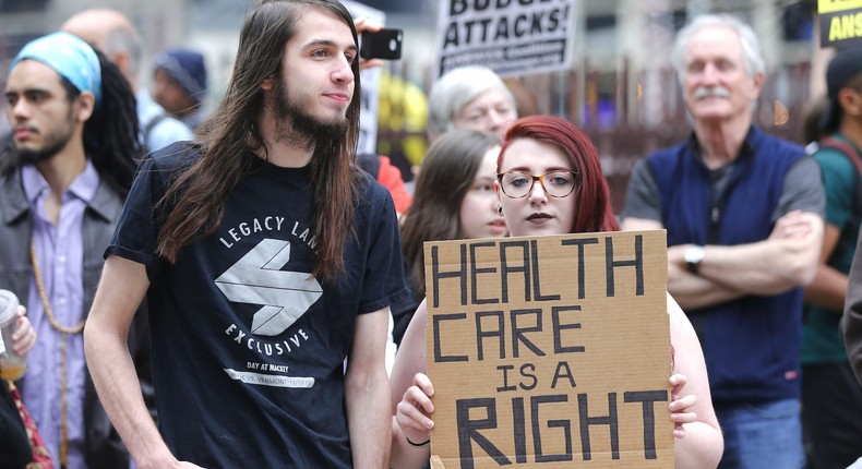 Protesters gather across the Chicago River from Trump Tower to rally against the repeal of the Affordable Care Act Friday, March 24, 2017, in Chicago.