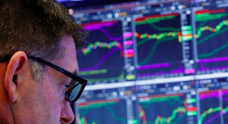 A trader works on the floor of the New York Stock Exchange shortly after the opening bell in New York