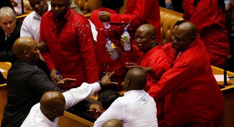 Party leader Julius Malema and members of his Economic Freedom Fighters (EFF) clash with Parliamentary security as they are evicted from the chamber in Cape Town, South Africa, May 17, 2016. 