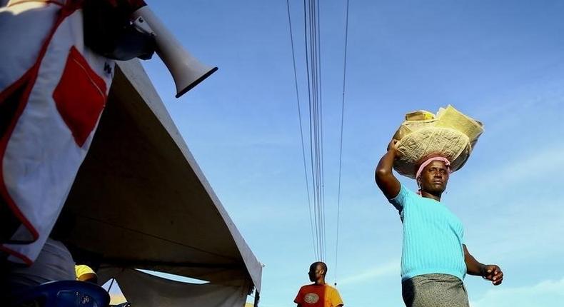 A man uses a loud-hailer to call out to the public to come for HIV/AIDS testing at a mobile testing unit in Ndeeba, a suburb in Uganda's capital Kampala May 16, 2014. REUTERS/Edward Echwalu