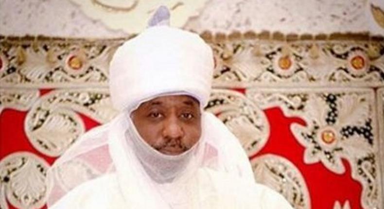 The Emir of Kano is seen holding his grand-daughter.