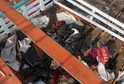 Discarded clothes and debris are seen on the deck of a fishing boat which carried Rohingya and Bangladeshi migrants to Indonesia, at a port in Lhokseumawe, Indonesia's Aceh Province