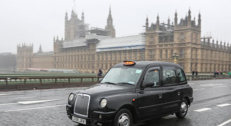 A black cab in front of the Houses of Parliament.Nicolas Economou/NurPhoto via Getty Images