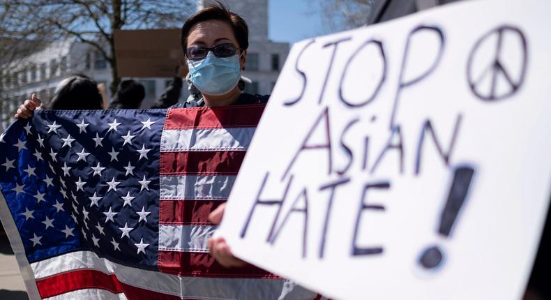 Lucy Lee, of Marietta, Ga., holds an American flag while rallying outside of the Georgia State Capitol in Atlanta during a unity Stop Asian Hate rally Saturday afternoon, March 20, 2021.AP Photo/Ben Gray