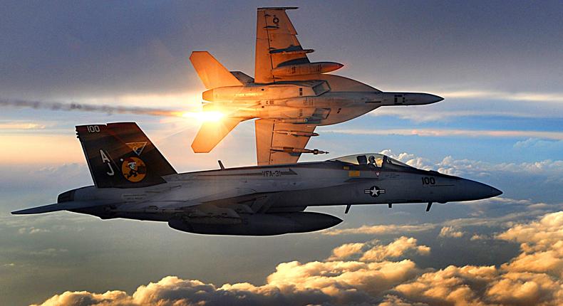 US Navy F/A-18E Super Hornets flying a combat patrol over Afghanistan in 2008. The aircraft in the background is deploying infrared flares.