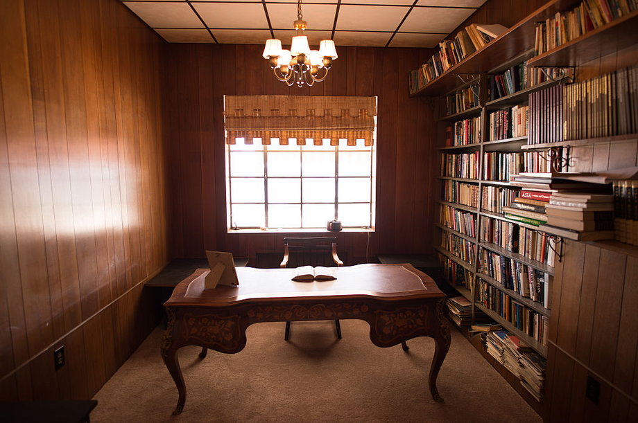 A total of 25 rooms are scattered throughout the mansion, including this wood-paneled library.