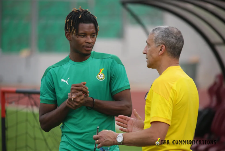 Chris Hughton talks to midfielder Edmond Addo