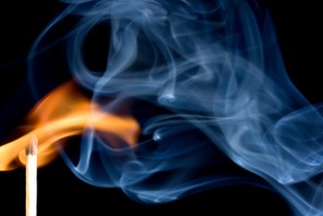 A match creating a flame with smoke