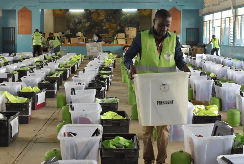 [FILE] An Independent Electoral and Boundaries Commission (IEBC) agent sorts ballot papers and boxes on October 25, 2017, at a polling station in Nairobi, a day before the scheduled repeat presidential poll.  (Photo BY SIMON MAINA/AFP via Getty Images)