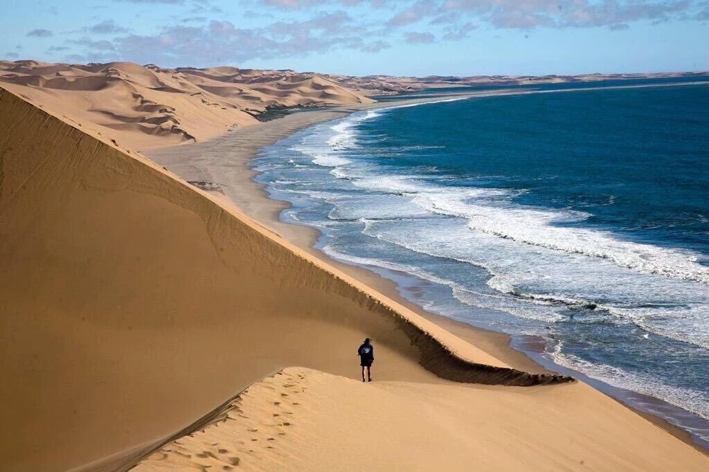 Surfing the world's highest sand dunes straight into the ocean in