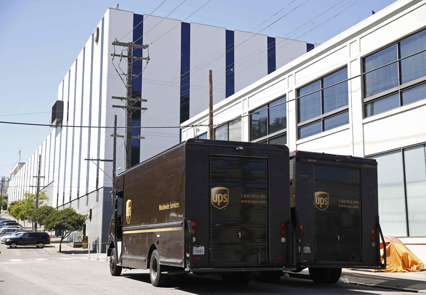 United Parcel Service vans are seen parked outside a UPS facility after a shooting incident was repo