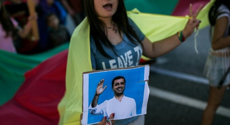 A Kurdish woman holds a photo of arrested HDP co-leader Selahattin Demirtas at a protest in Athens, Greece