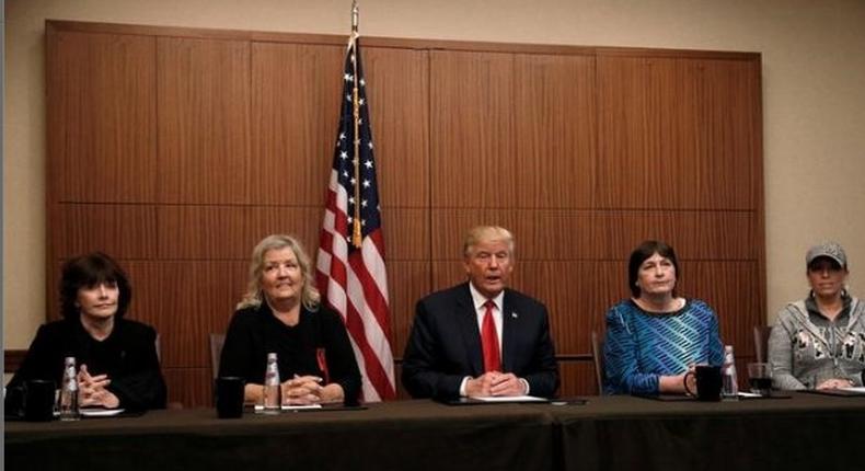 Republican presidential nominee Donald Trump sits with (from R-L) Paula Jones, Kathy Shelton, Juanita Broaddrick, Kathleen Willey in a hotel conference room in St. Louis, Missouri, U.S., shortly before the second presidential debate at Washington University in St. Louis, October 9, 2016.
