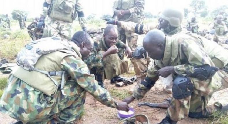 Soldiers sharing their food together