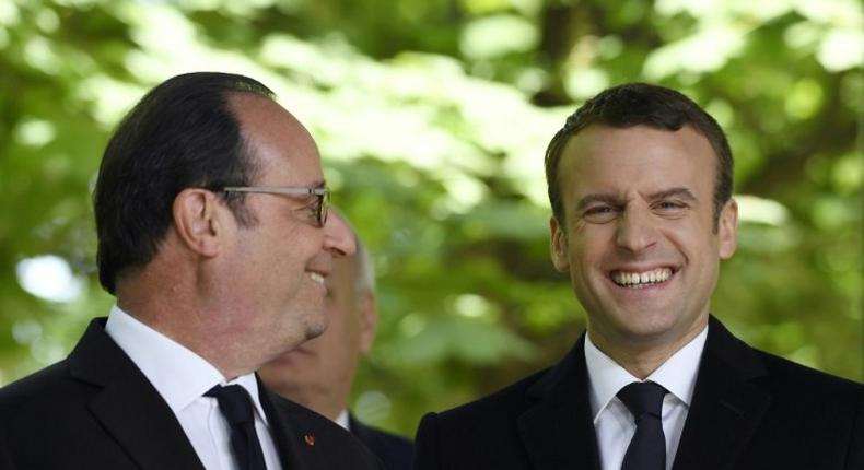 French President Francois Hollande (left) is pictured on Wednesday with his successor centrist Emmanuel Macron