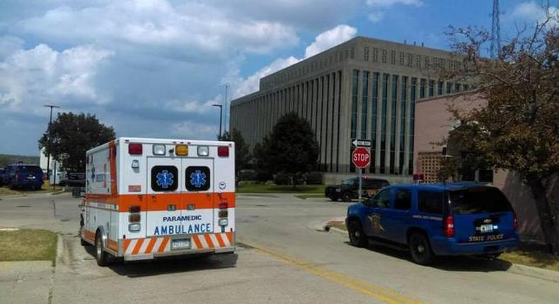 An ambulance is seen outside the Berrien County Courthouse in St. Joseph, Michigan, U.S., where a gunman opened fire killing two bailiffs and injuring a civilian and a sheriff's deputy before being shot dead, July 11, 2016.