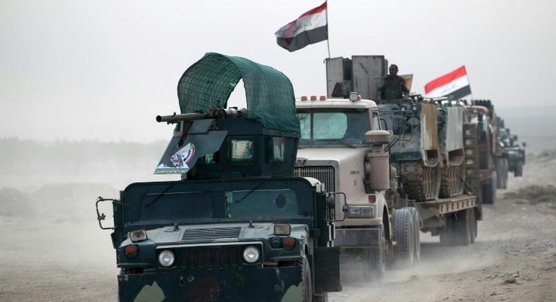 Shiite fighters drive their vehicles towards the village of Umm Sijan, south of Mosul, on October 31, 2016 during Iraqi forces' operation to recapture the main hub city from the Islamic State