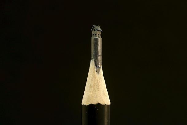 A miniature sculpture in the shape of a home, created by Jasenko Djordjevic on a graphite pencil, is