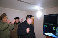 North Korea's leader Kim Jong Un is seen as the newly developed intercontinental ballistic rocket Hw