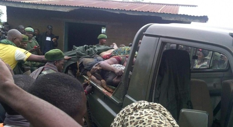 People gather around a truck transporting the victims of a wave of unrest and violence in Beni, Democratic Republic of Congo, in August 2016