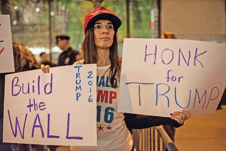 A supporter of Republican Presidential candidate Donald Trump stands across the street from a protest held by a number of Latino organizations outside of NBC Studios on November 7, 2015, in New York City.