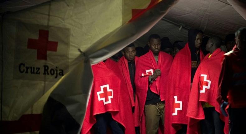 Migrant people in a Red Cross tent on their arrival on a Spanish coast guard vessel at the southern Spanish port of Malaga on February 26, 2017