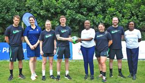 Standard Chartered's Joyce Kibe (centre white shirt) welcomes LFC Coaches to Kenya