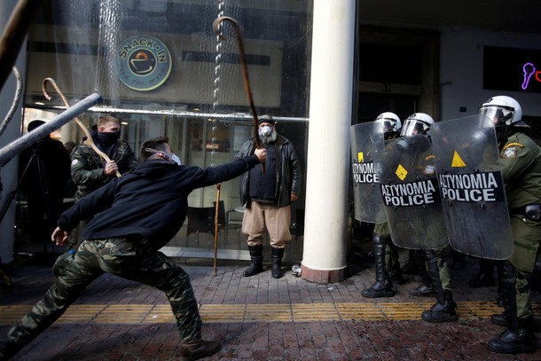 Farmers from the island of Crete clash with riot police during a demonstration outside the Agricultu