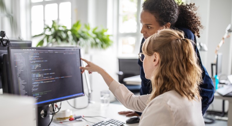 Approaching a coworker at their desk for an unscheduled chat has been dubbed desk-bombing.Luis Alvarez/Getty Images