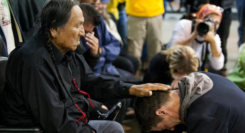 Leonard Crow Dog lays his palm on Wes Clark Jr.