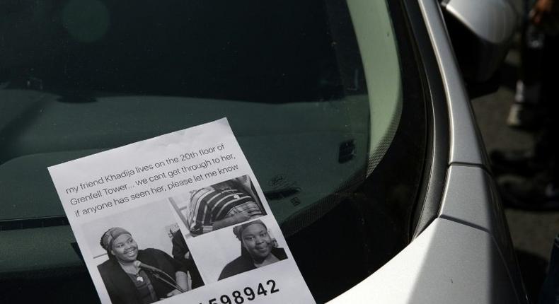 A flyer for a missing person Khadija Saye pictured on a car near a temporary casualty bureau opened for people affected by the fire at Grenfell Tower, a residential block of flats in west London, on June 14, 2017