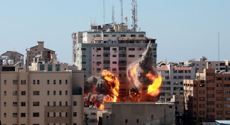 Fire erupts from the Al-Jalaa Tower as it's destroyed in an Israeli airstrike in Gaza city controlled by the Palestinian Hamas movement, on May 15, 2021.
