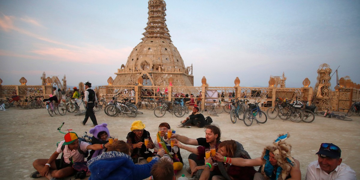 Burning Man participants toasting outside the Temple of Grace in 2014.