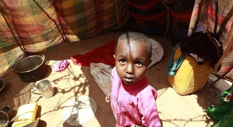 A displaced child stands inside their makeshift shelter structure at the Qansahaley settlement camp in Dollow town, along the Somalia-Ethiopia border, August 30, 2011. REUTERS/Thomas Mukoya