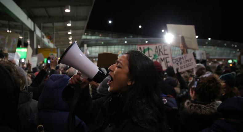 Protesters gathered outside Terminal 4 at John F. Kennedy International Airport on Saturday in opposition to President Donald Trump's proposed ban on immigration.