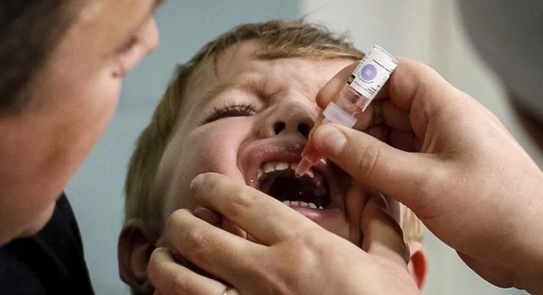 A boy receives polio vaccine drops at a clinic in Kiev, Ukraine.