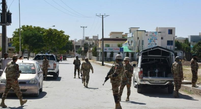 Pakistani soldiers stand guard at the site where a Chinese couple was kidnapped in the neighbourhood of Jinnah town in Quetta on May 24, 2017