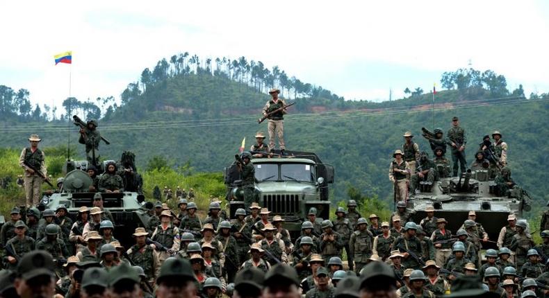 Venezuelan troops in different fatigues and carrying various weapons attend a press conference given by Defence Minister general Vladimir Padrino Lopez in Caracas on August 14, 2017