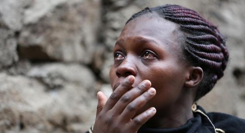 A woman reacts as rescue workers search for residents feared trapped in the rubble of a six-storey building that collapsed after days of heavy rain, in Nairobi, Kenya April 30, 2016. 