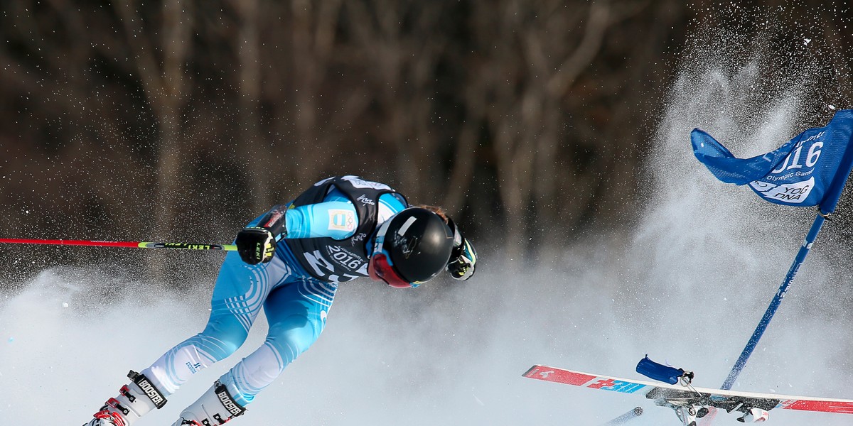 Francesca Baruzzi Farriol of Argentina crashes after losing her ski during the women's Alpine Skiing Giant Slalom at the Hafjell Olympic Slope at the Winter Youth Olympic Games.