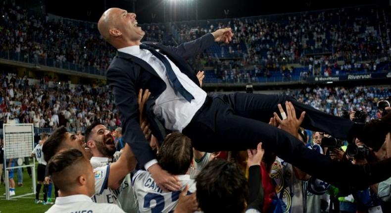 Real Madrid's head coach Zinedine Zidane is tossed by players