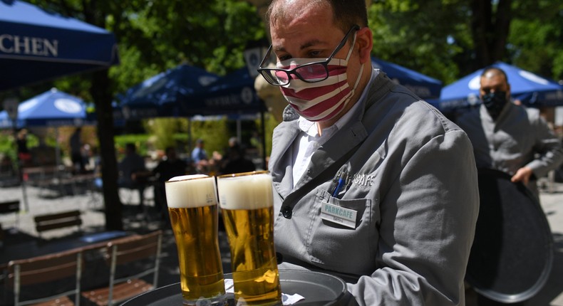 A waiter serves beer in Munich, Germany, in May 2020 amid the COVID-19 pandemic.