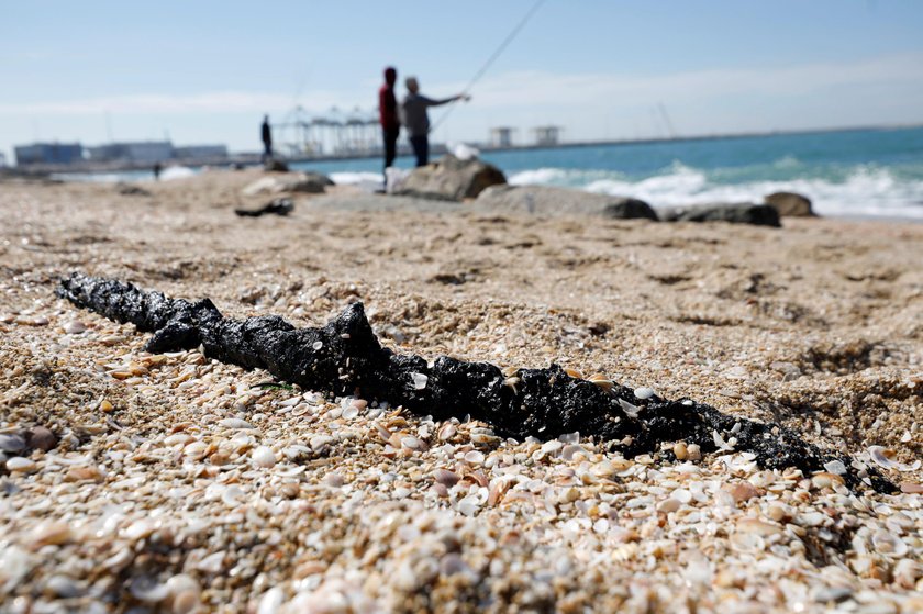 Israel's beaches blackened by tar after offshore oil spill