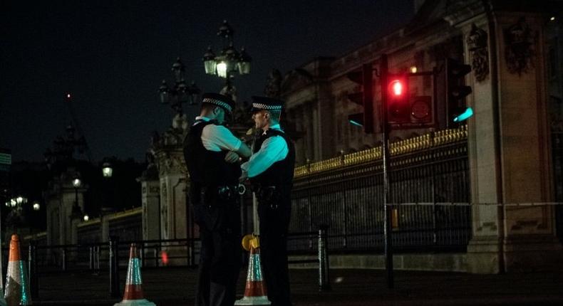 Police officers stand guard at a police cordon next to Buckingham Palace following an incident where a man armed with a knife was arrested outside the palace following a disturbance in London on August 26, 2017