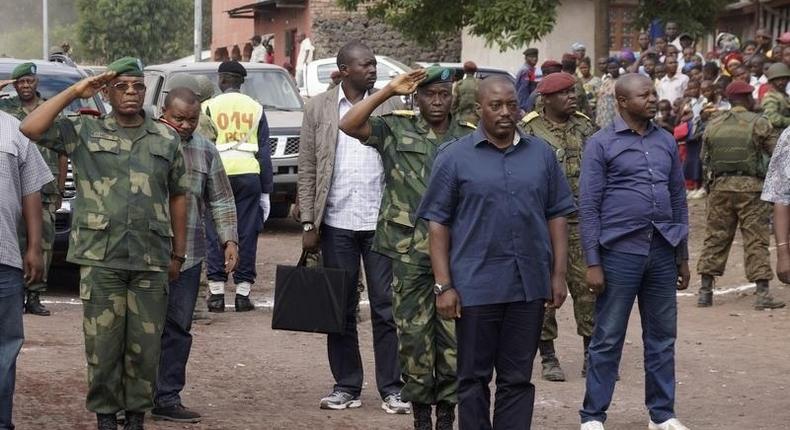 Democratic Republic of Congo's President Joseph Kabila (front C) stands for the national anthem along a street in Goma, a town in eastern Democratic Republic of the Congo, November 30, 2013. REUTERS/Kenny Katombe