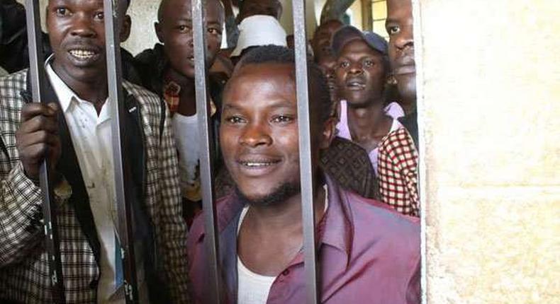 Julius Mwithalii (right) at the Maua Law Courts cells after appearing before Senior Resident Magistrate Antony Munene where he was charged with attempted suicide. 