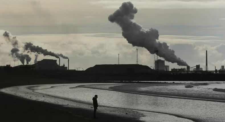 A man walks his dog on Aberavon beach near Port Talbot in WalesGetty Images