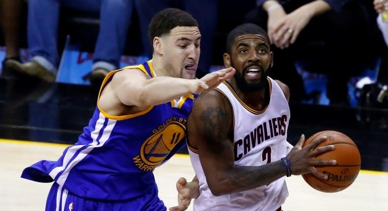 Kyrie Irving (R) of the Cleveland Cavaliers is defended by Klay Thompson of the Golden State Warriors in game four of the 2017 NBA Finals, at Quicken Loans Arena in Cleveland, Ohio, on June 9