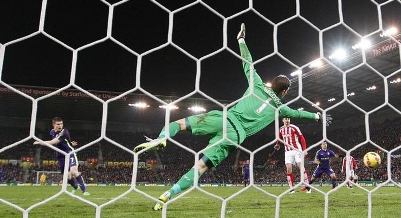 Manchester City's James Milner scores past Asmir Begovic of Stoke City during their English Premier League soccer match at the Britannia Stadium in Stoke-on-Trent, central England, February 11, 2015.      REUTERS/Darren Staples