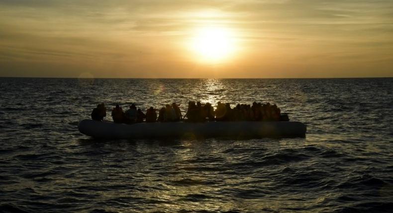 Migrants and refugees sit on a rubber boat before to be rescued by the ship Topaz Responder run by Maltese NGO Moas and Italian Red Cross off the Libyan coast in the Mediterranean Sea, on November 5, 2016 off the coast of Libya